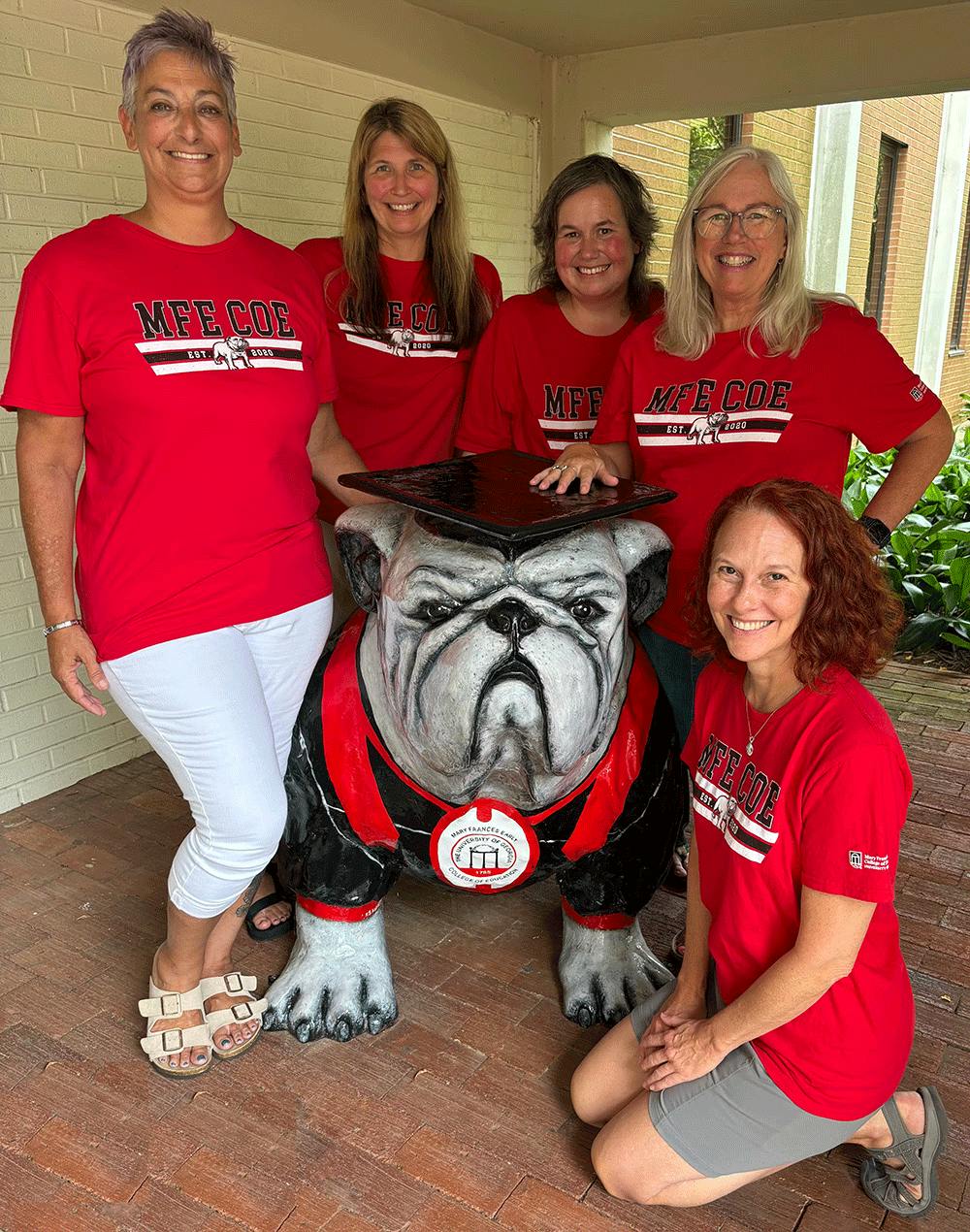 photo of GSAP Team members, wearing matching red college of education t-shirts standing around a bulldog statue