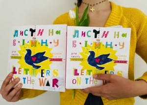 Person holding two copies of "Letters from the War"