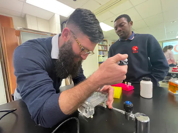 Shaugnessy and Ngutor loading a gel at the teacher workshop