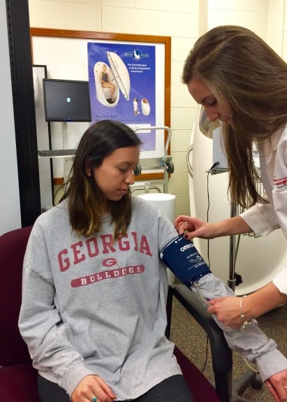 Blood pressure measurement following proper techniques. The participant's blood pressure is stabilized after resting for 5 minutes, sitting up straight with both feet flat on the ground with the cuff being placed ~2.5 cm above the bend.
