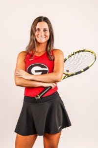 Amazing student Meg Kowalski poses with a tennis racket
